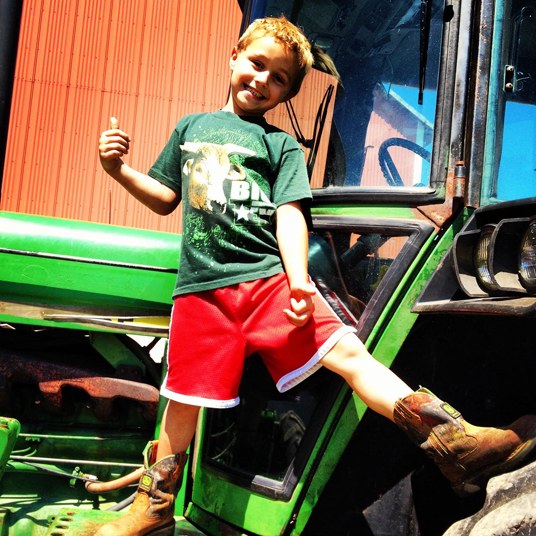 Carson Hickle standing on a tractor