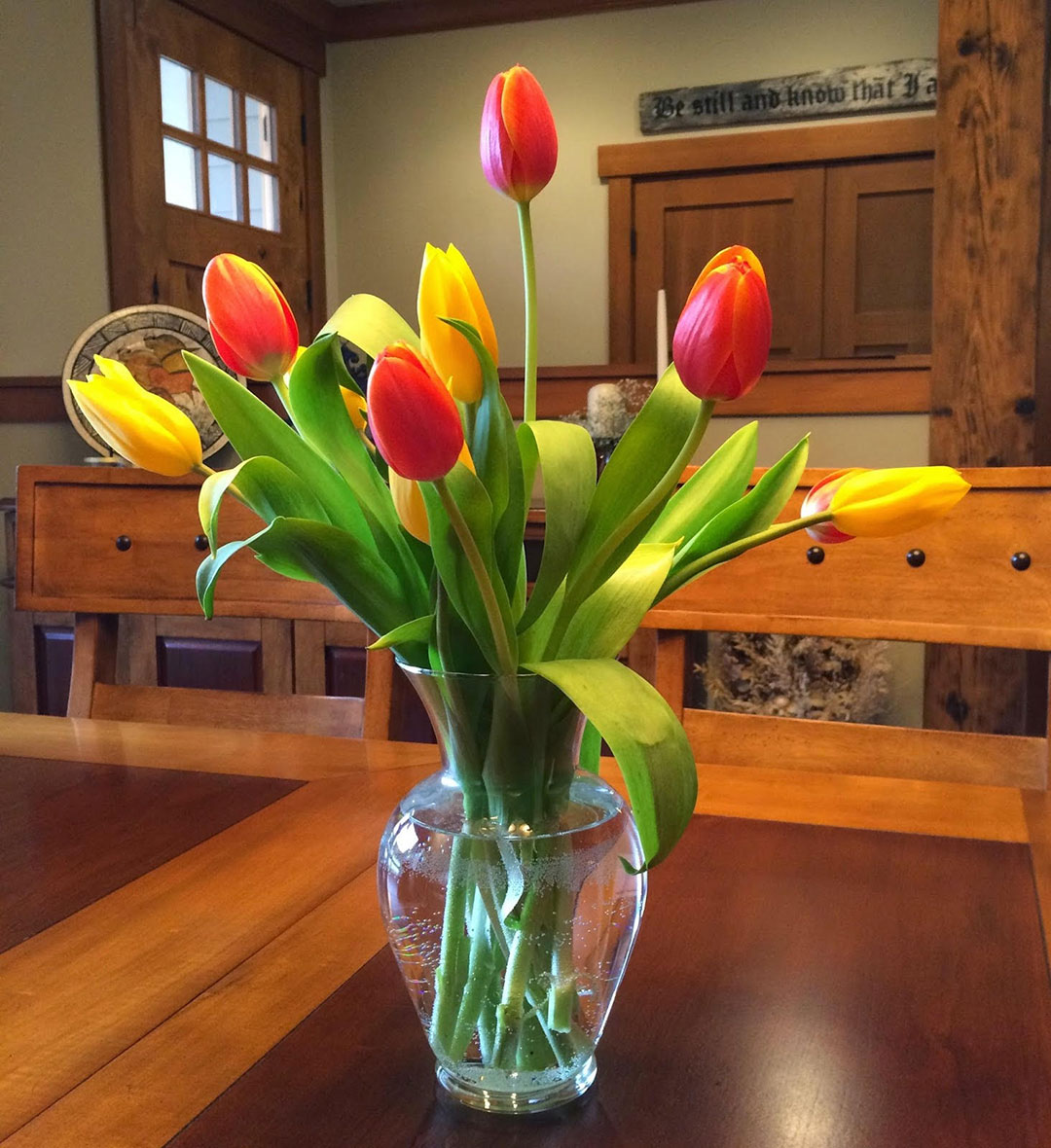 Tulips on the dining room table in a glass vase