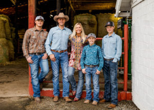 Hickle Family Standing in Barn Smiling